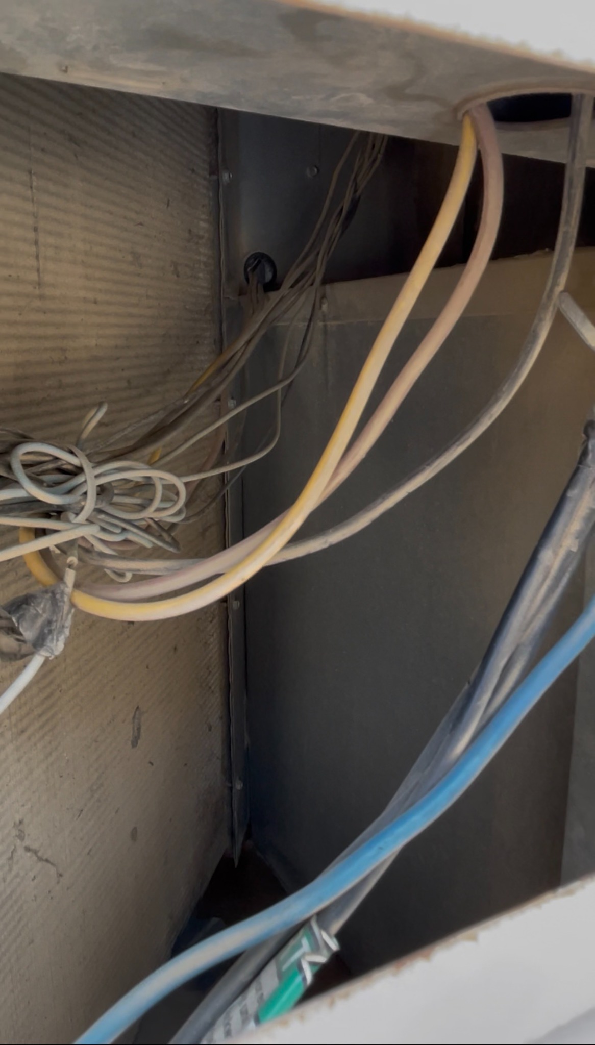 Internal HVAC installation showing ductwork, wiring and service connections