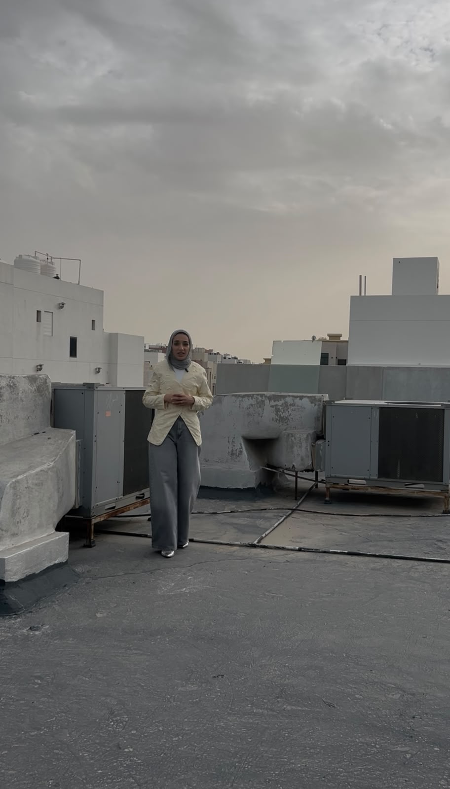Shaikha presenting beside rooftop HVAC equipment